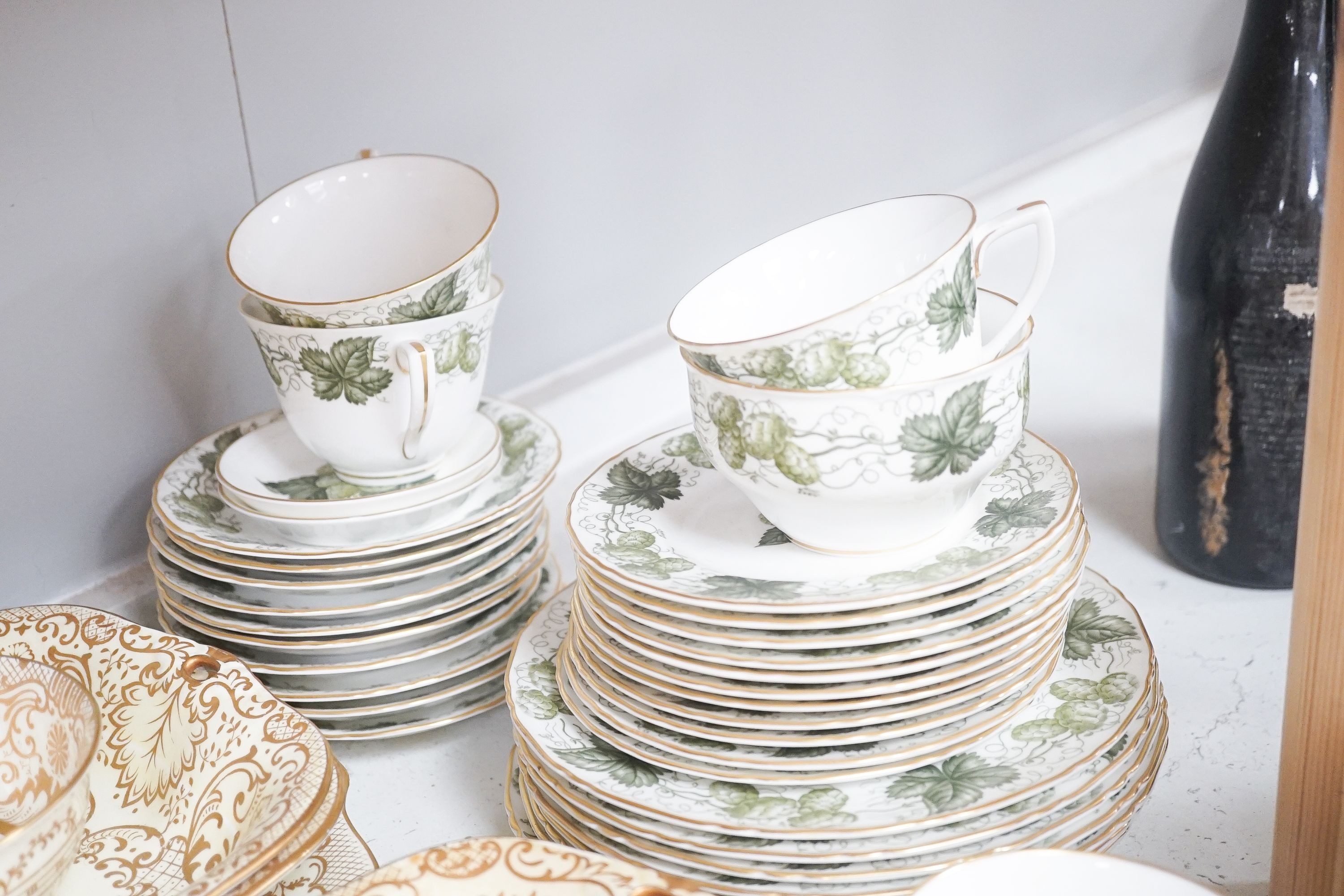 A Crown Staffordshire fifty nine piece part tea set and dessert service, central flowers and gilt borders